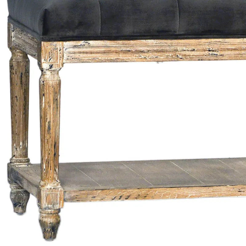 Padded bench with tufted detailing and storage shelf, charcoal gray.